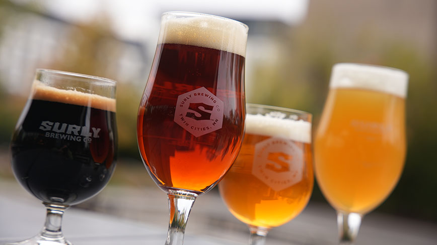 Four beers on a table at Surly Brewing Company showing different colors of Simposons Golden Promise malt beers