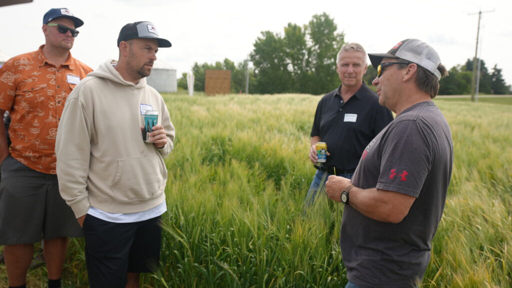 Brewers visit with farmer at Davidson Brothers Farm in Alberta, Canada.