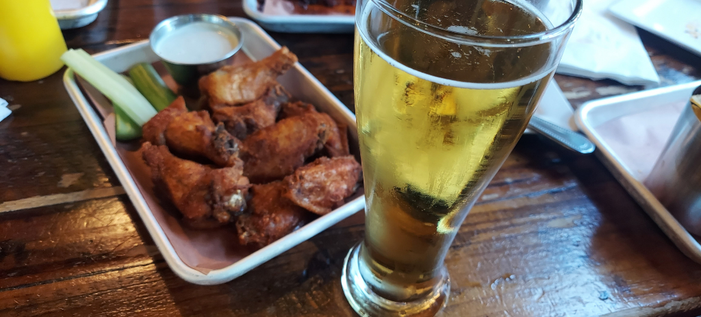 Jasmine Rice Lager at Northbound Smokehouse & Brewpub with food in background